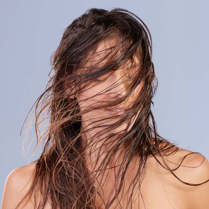 woman with natural hair oils needing to wash her hair