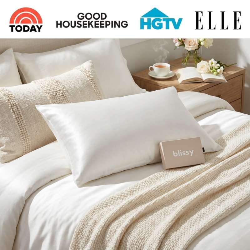 Blissy silk pillowcase on a neatly made bed with media logos highlighting expert recognition for skin and hair benefits